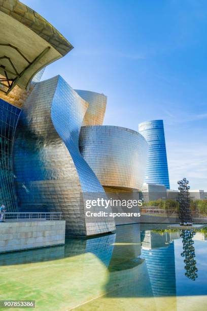 guggenheim museum, and iberdrola tower, bilbao, spain - bilbao spain stock pictures, royalty-free photos & images