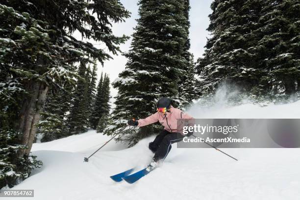 female athlete powder skiing - woman skiing stock pictures, royalty-free photos & images