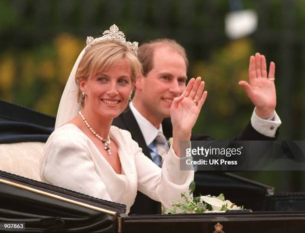 Britain's Prince Edward and Sophie Rhys-Jones wave to the crowd from an open carriage after being married in St. George's Chapel within the grounds...