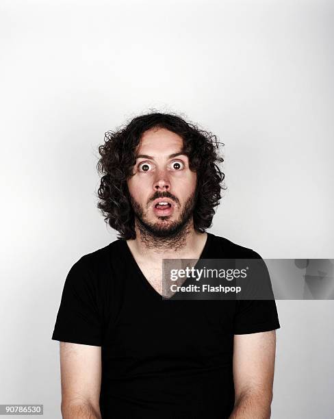 portrait of man looking surprised - surprised expression stock-fotos und bilder