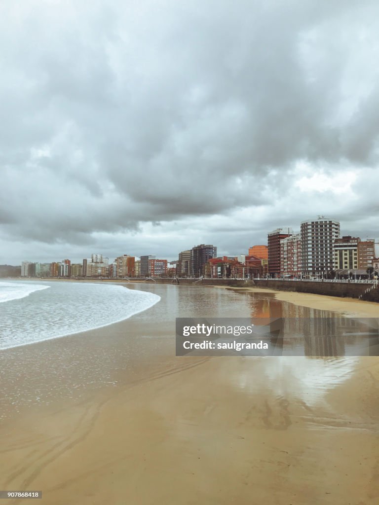 Buildings reflected on the beach