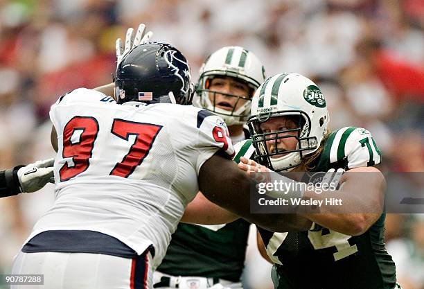 Nick Mangold of the New York Jets blocks Frank Okam of the Houston Texans at Reliant Stadium on September 13, 2009 in Houston, Texas. The Jets...