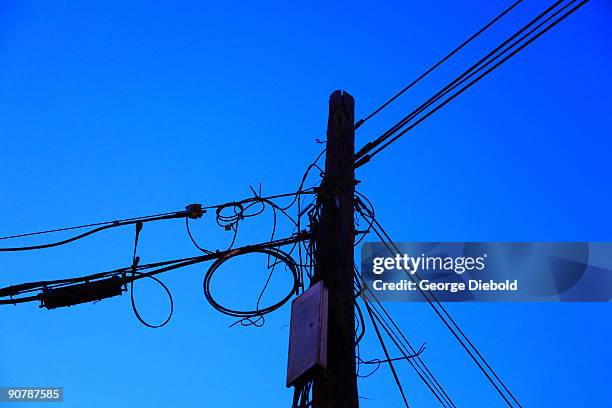 cluttered telephone pole - aerial cable stock pictures, royalty-free photos & images