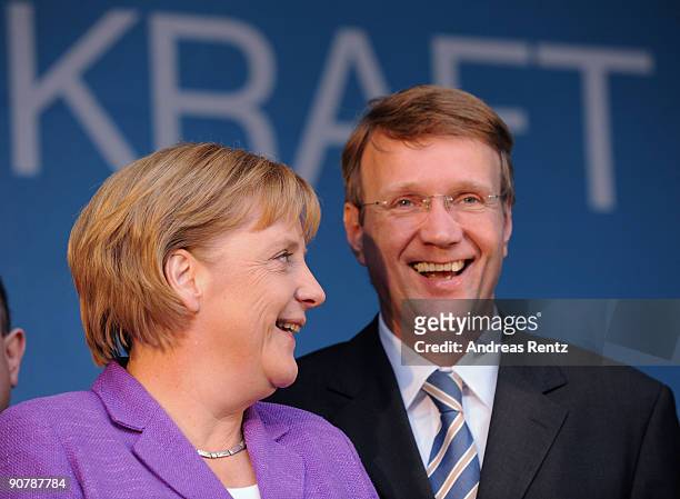 German Chancellor Angela Merkel of the Christian Democratic Union and Ronald Pofalla , General Secretary of the CDU smile during their campaign rally...