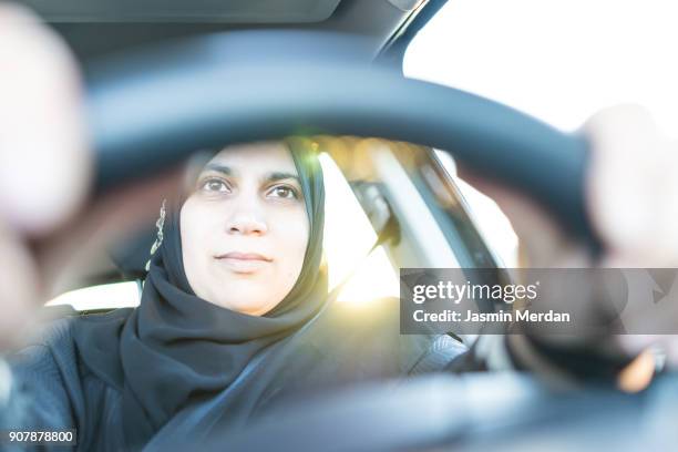 happy middle eastern woman driving a car - arab woman driving stockfoto's en -beelden