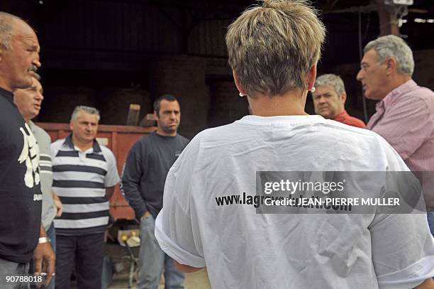 French milk producer Annick speaks with colleagues in Sainte-Colombe-en-Bruilhois, southwestern France, on September 15 at her dairy farm. In France...