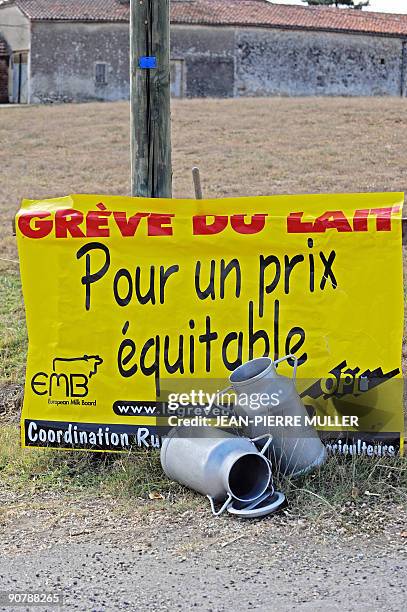 Board reading "milk strike for a fair price" is set in a field in Sainte-Colombe-en-Bruilhois, southwestern France, on September 15 at a dairy farm....