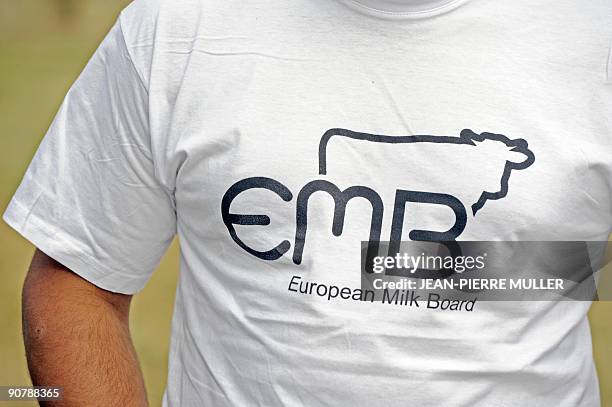 French milk producer wears a tee-shirt with EMB logo in Sainte-Colombe-en-Bruilhois, southwestern France, on September 15 at her dairy farm. In...