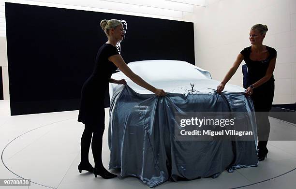 Two women reveal the new Rolls-Royc Ghost car at the international motor show IAA on September 15, 2009 in Frankfurt am Main, Germany. The world's...