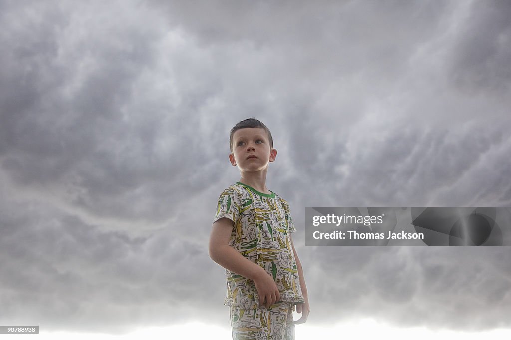 Boy in front of stormy skies