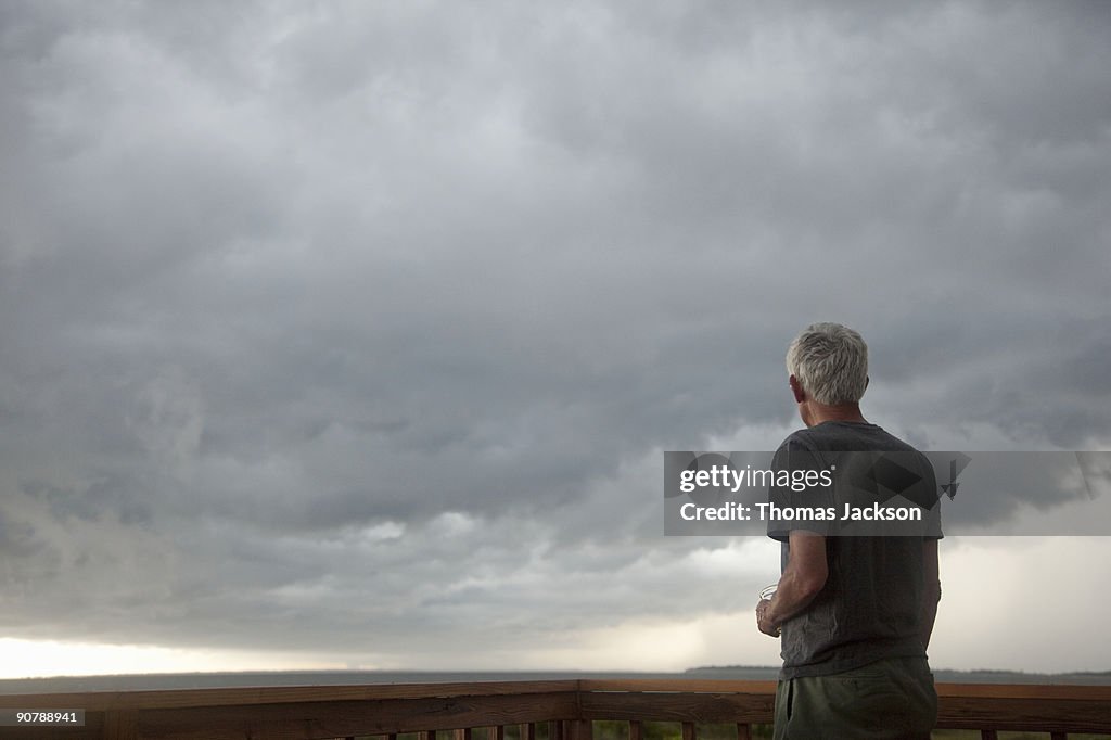 Man in front of stormy skies