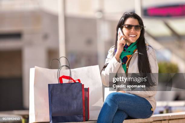fashion young woman resting after shopping and using cellphone - venezuelan girls stock pictures, royalty-free photos & images
