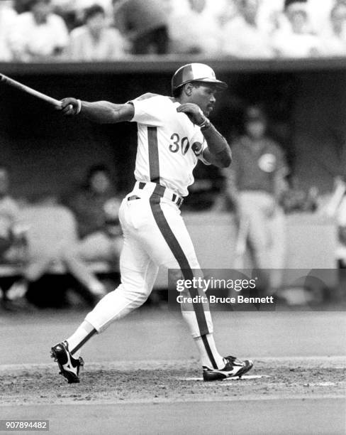 Tim Raines of the Montreal Expos swings at the pitch during an MLB game against the Chicago Cubs circa 1986 at Olympic Stadium in Montreal, Quebec,...