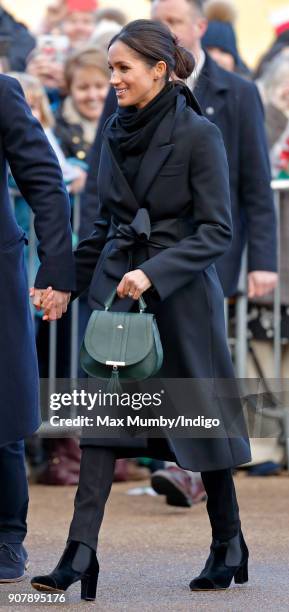 Meghan Markle holds Prince Harry's hand as they visit Cardiff Castle on January 18, 2018 in Cardiff, Wales.