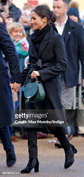 Meghan Markle holds Prince Harry's hand as they visit Cardiff Castle on January 18, 2018 in Cardiff, Wales.
