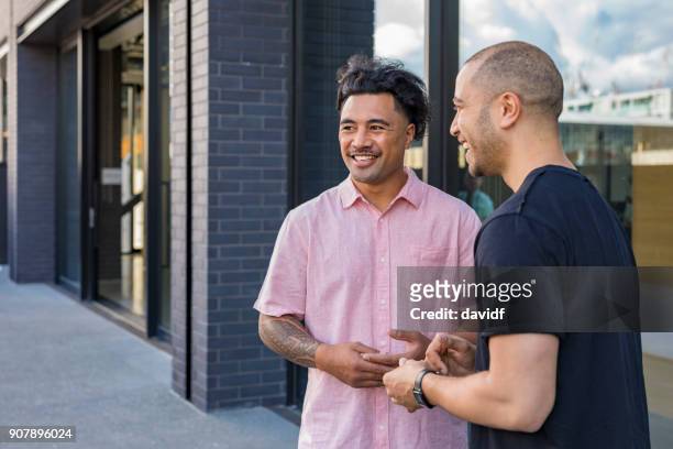pacific islander business men meeting outside an office building - friendly small business talking stock pictures, royalty-free photos & images