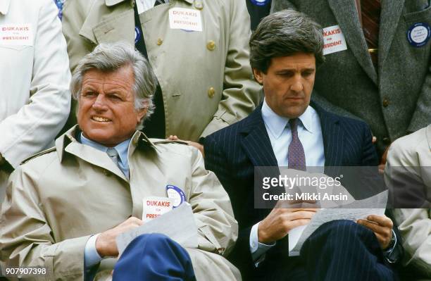 Senator Ted Kennedy and former Lt. Governor John Kerry listen as Presidential candidate Michael Dukakis announces he is running for president in...