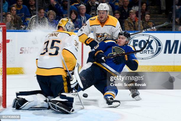 Dmitrij Jaskin of the St. Louis Blues falls to the ice as Anthony Bitetto and Pekka Rinne of the Nashville Predators defend the net at Scottrade...