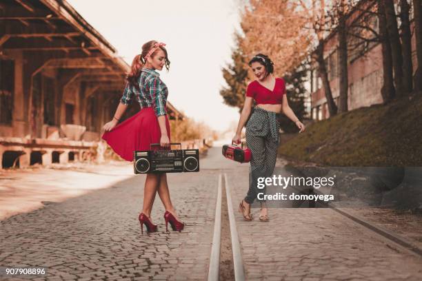 playful pin-up women having fun with a boom box - pin up wall stock pictures, royalty-free photos & images