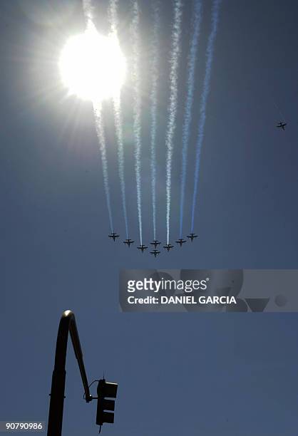 Eight French Air Force Alphajet aircrafts fly in arrow formation over 9 de Julio avenue in Buenos Aires as part of the the French contribution to the...