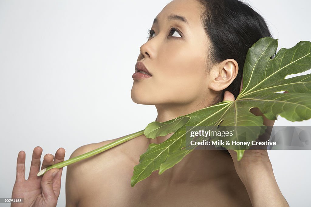 Woman holding big leaf