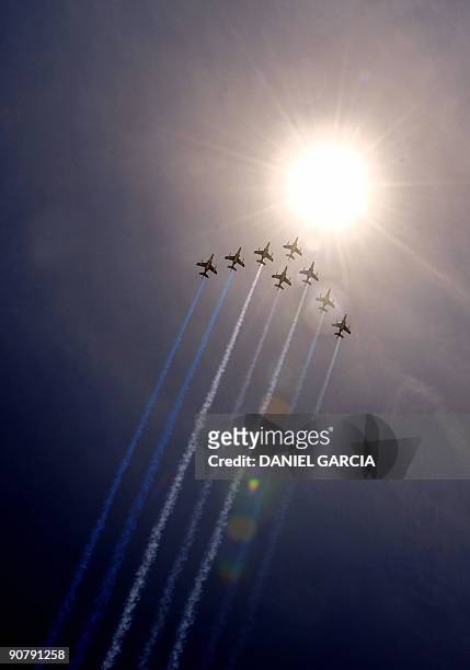 Eight French Air Force Alphajet aircrafts fly in arrow formation over 9 de Julio avenue in Buenos Aires as part of the the French contribution to the...