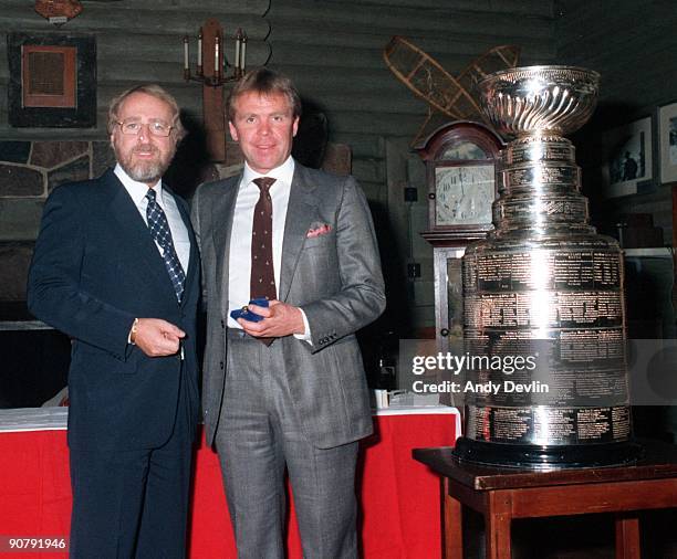 Owner Peter Pocklington and Head Coach Glen Sather of the Edmonton Oilers pose for a photo next to the Stanley Cup circa 1984-85 in Edmonton,...