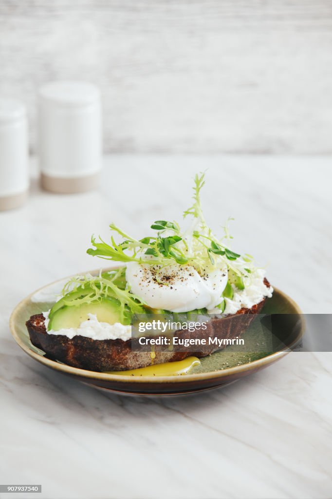 Bruschetta with avocado, ricotta and poached egg