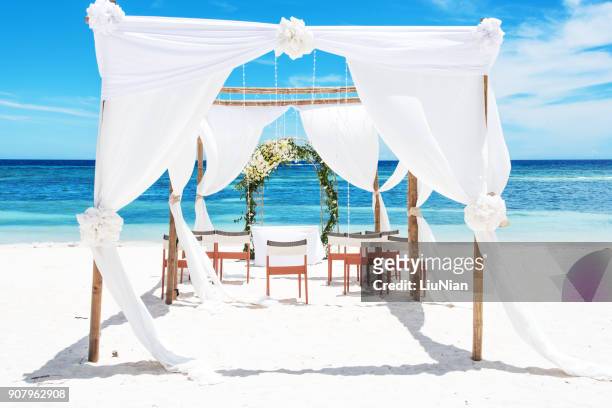tropical paradise beach wedding setting - beach pavilion stock pictures, royalty-free photos & images