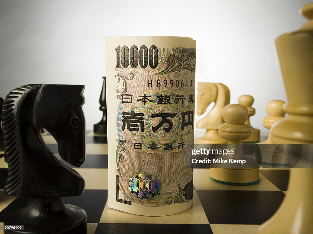 Rolled currency on a chess board