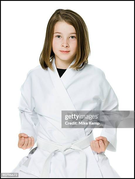 youth practicing martial arts - karate girl stock-fotos und bilder