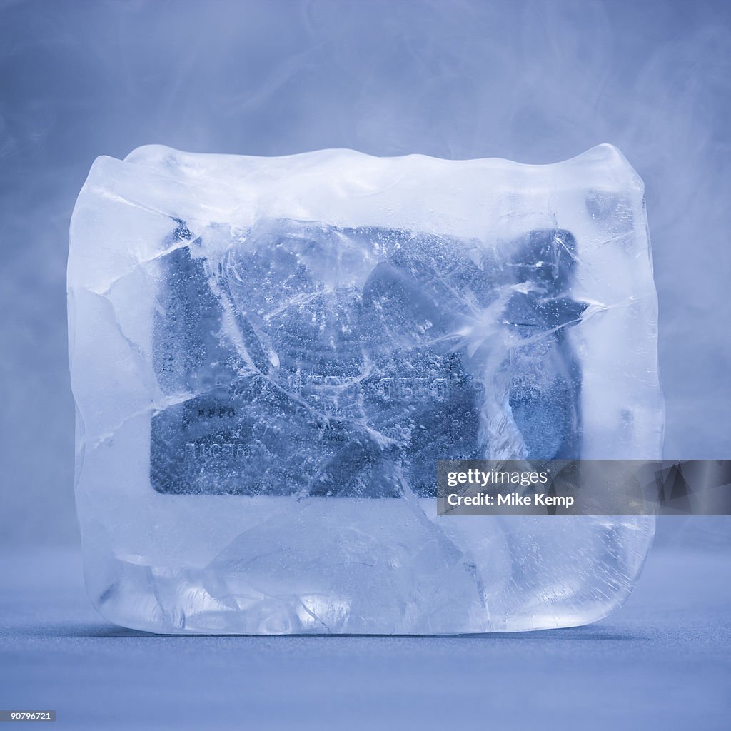 Credit card frozen in a solid block of ice
