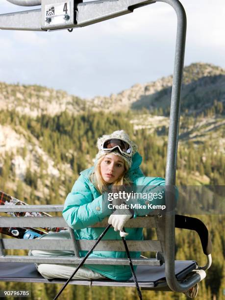 skier on a chairlift waiting for it to snow - mismatch stock pictures, royalty-free photos & images