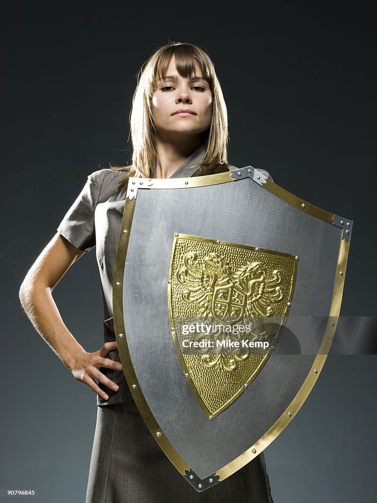 Businesswoman holding a shield