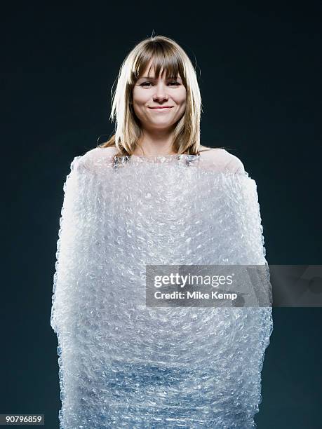 woman wrapped in bubble wrap - bubble wrap stock pictures, royalty-free photos & images