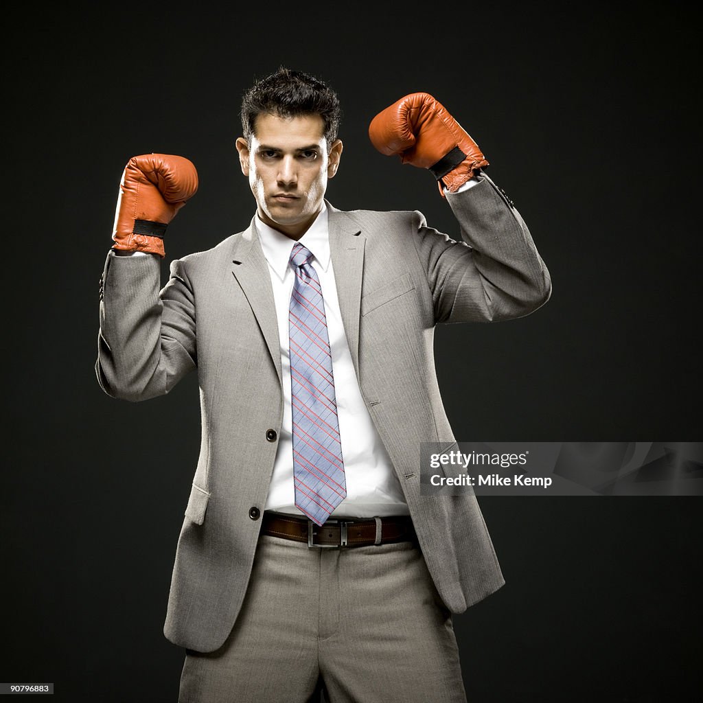 Businessman wearing boxing gloves