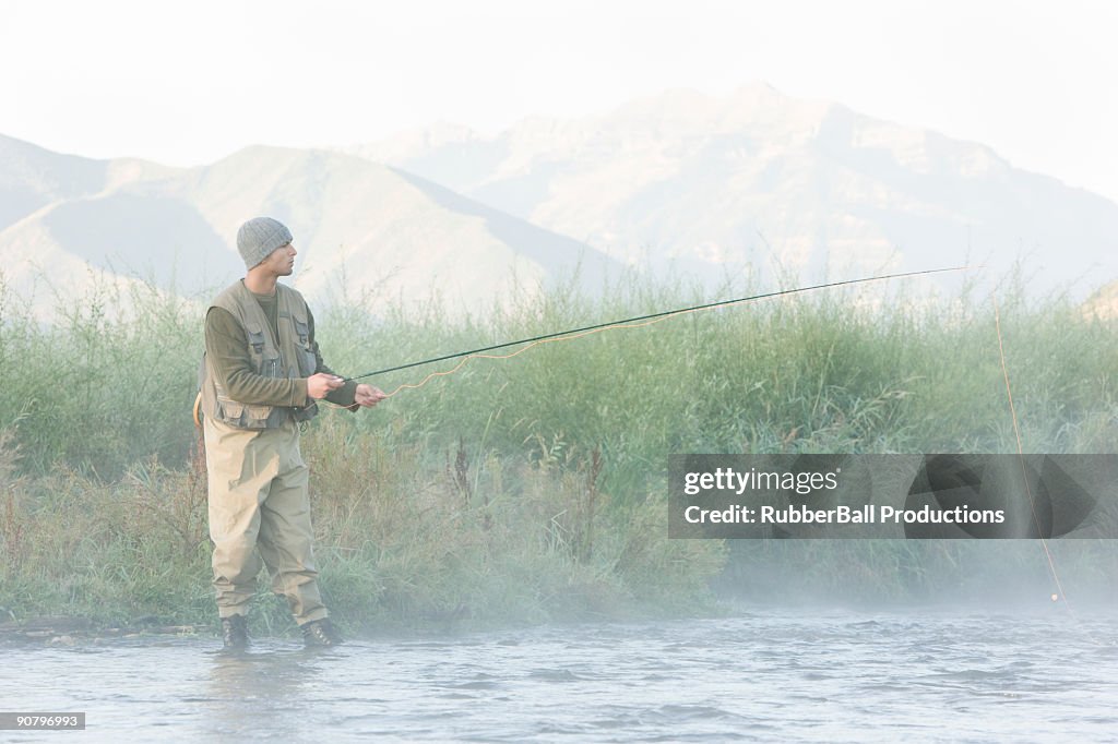 Fly fisherman fishing in a mountain river