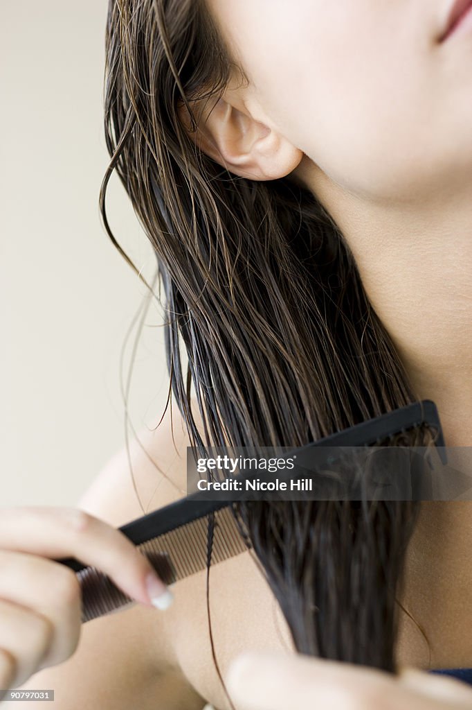 Woman combing her hair