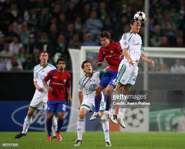 Christian Gentner of Wolfsburg and Georgi Schennikov of Moscow battle for the ball during the UEFA Champions League Group B match between VfL...