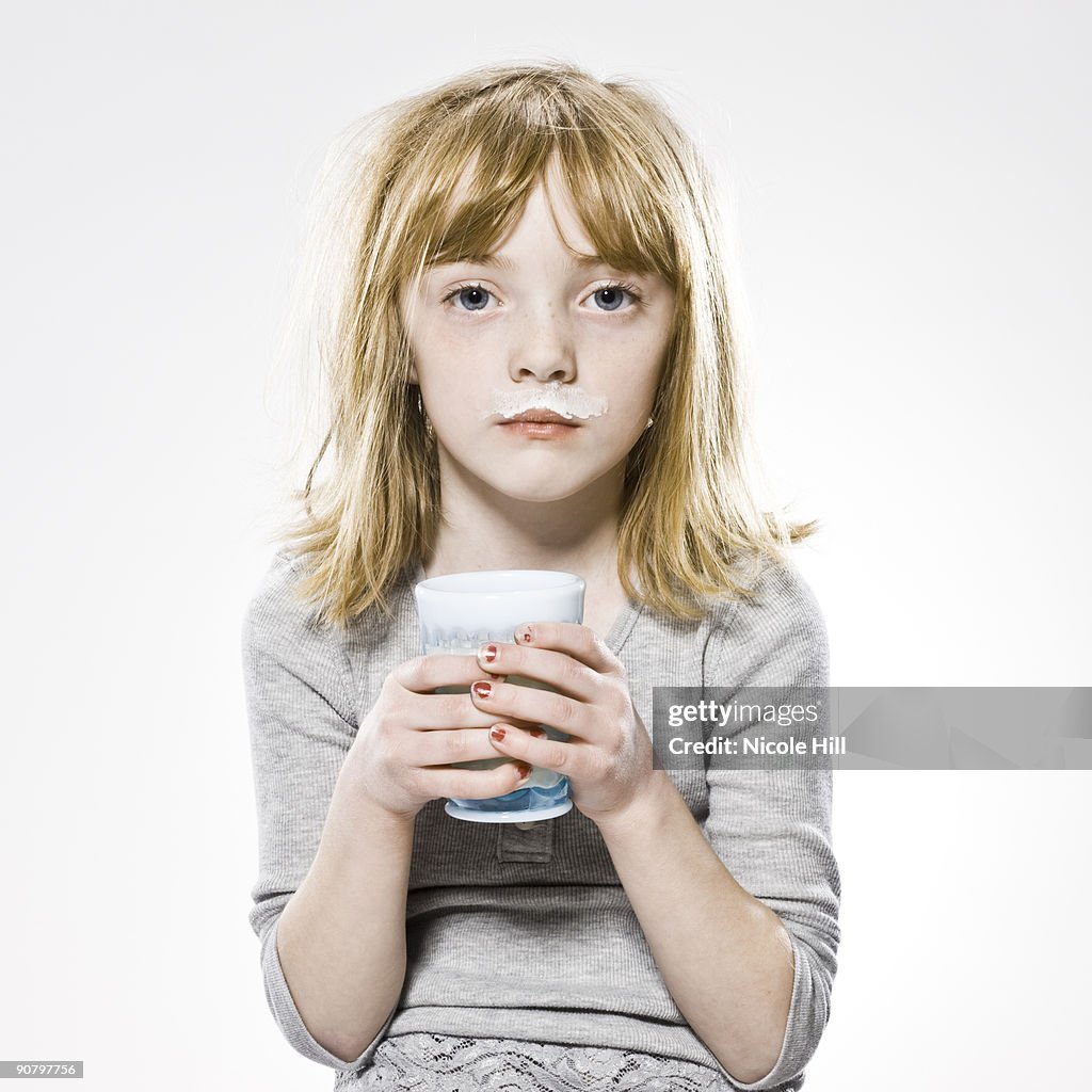 Girl looking at the camera with milk mustache