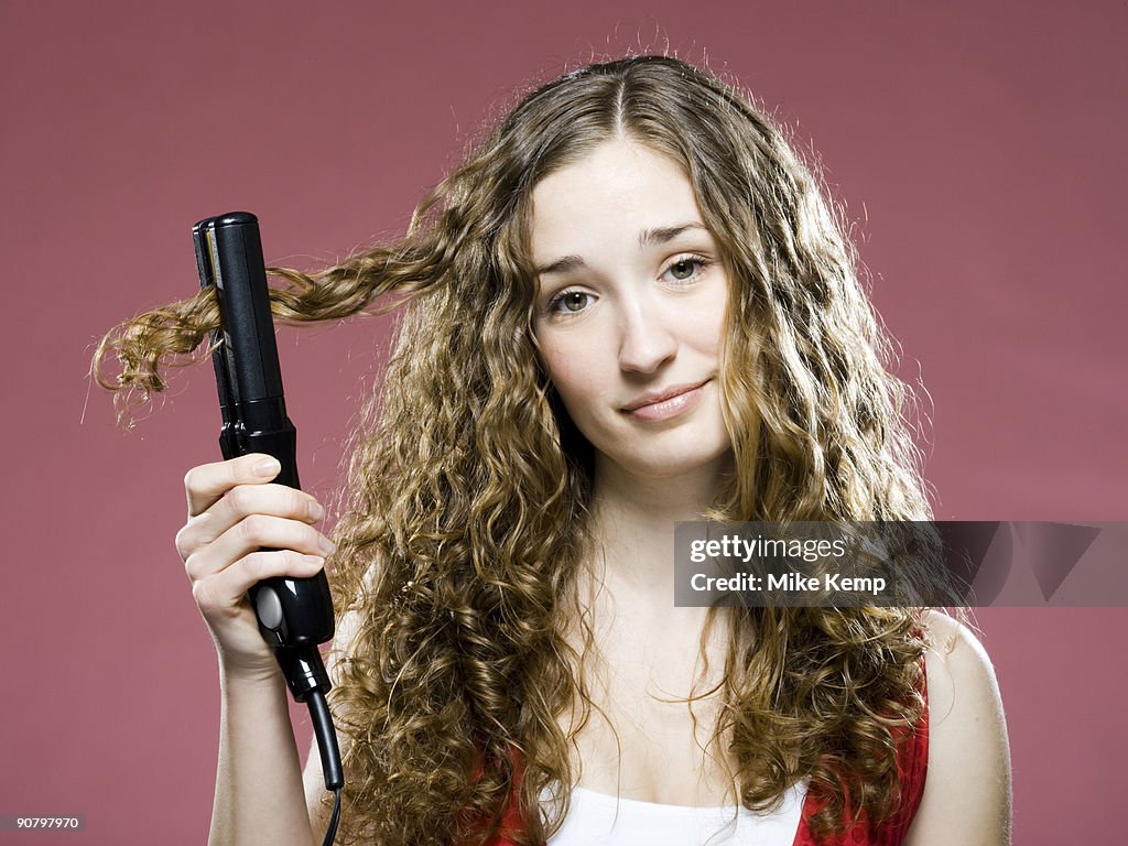 Woman trying to straighten her hair