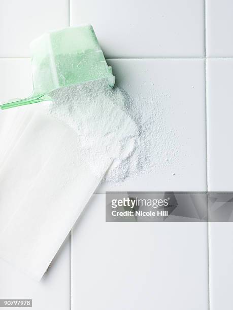 laundry detergent and dryer sheet on a white tile countertop - washing powder stock-fotos und bilder
