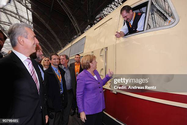 German Chancellor Angela Merkel chats with the engine driver during an election rally on September 15, 2009 in Leipzig, Germany. German Chancellor...