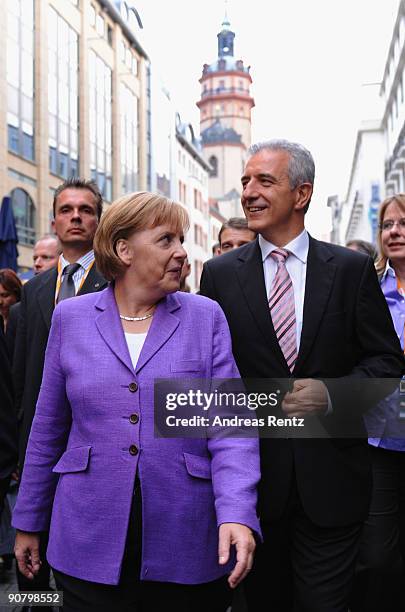 German Chancellor Angela Merkel and Saxony's Governor Stanislaw Tillich walk during an election rally on September 15, 2009 in Leipzig, Germany....