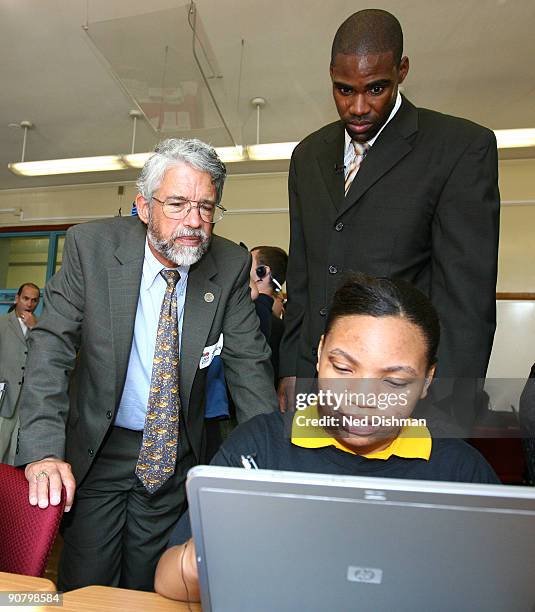 Director of the White House Office of Science and Technology Policy John Holdren and Antawn Jamison of the Washington Wizards interact with a student...