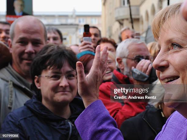 German Chancellor Angela Merkel of the Christian Democratic Union greets supporters during her election campaign rally in the historic 'Rheingold'...