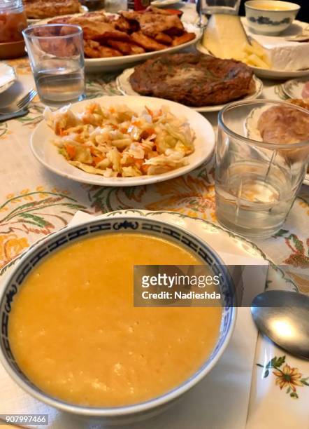 carrot cream soup at a table with family lunch shot. - dried herring stock pictures, royalty-free photos & images