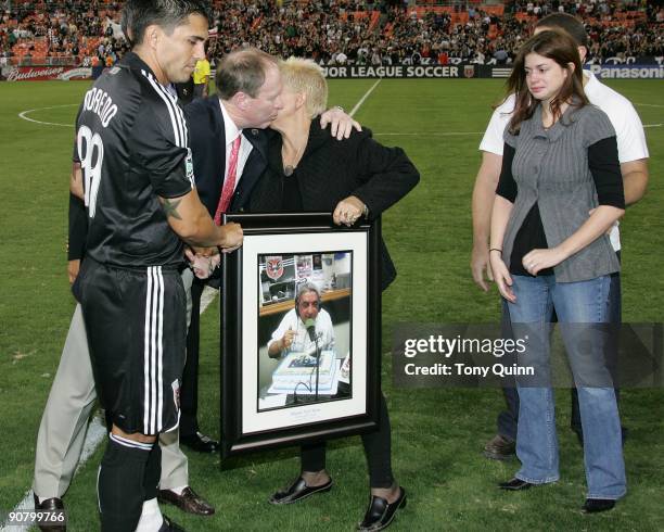 Kevin Payne president and Jaime Moreno of D.C. United make a presentation to the family of the late Danilo Noel Diron who was inducted into the...