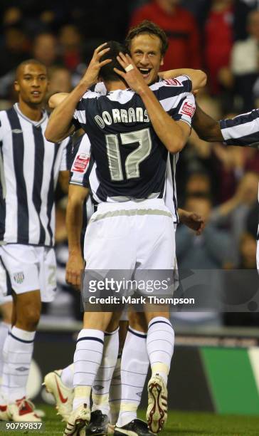 Jonas Olsson of West Bromwich Albion celebrates his second goal with team mate Graham Dorrans during the Coca-Cola Championship match between West...