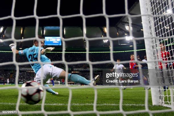 Grafite of Wolfsburg scores his third goal past goalkeeper Igor Akinfeev of Moscow during the UEFA Champions League Group B match between VfL...
